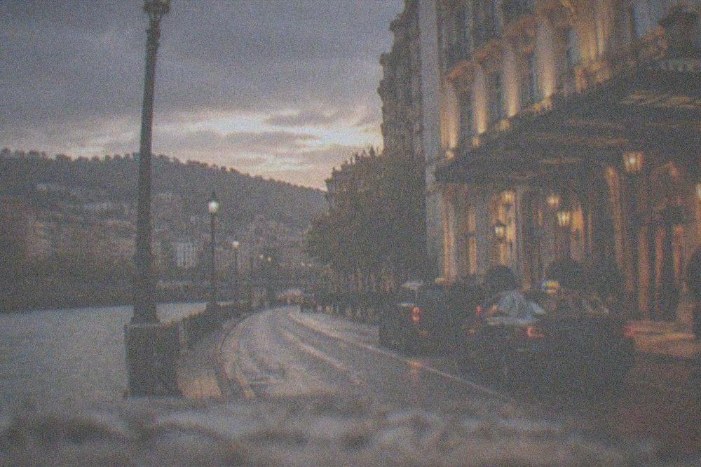 Evening light on a grand hotel facade in central Bilbao with taxis waiting at the entrance