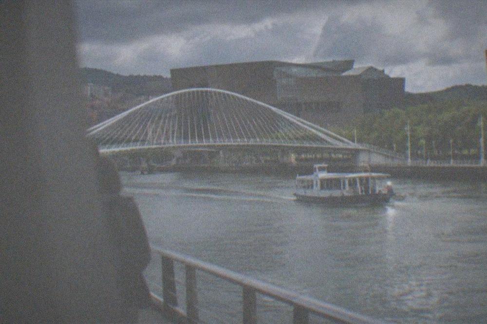 The Zubizuri footbridge over the Nervion estuary with the Euskalduna Palace behind it