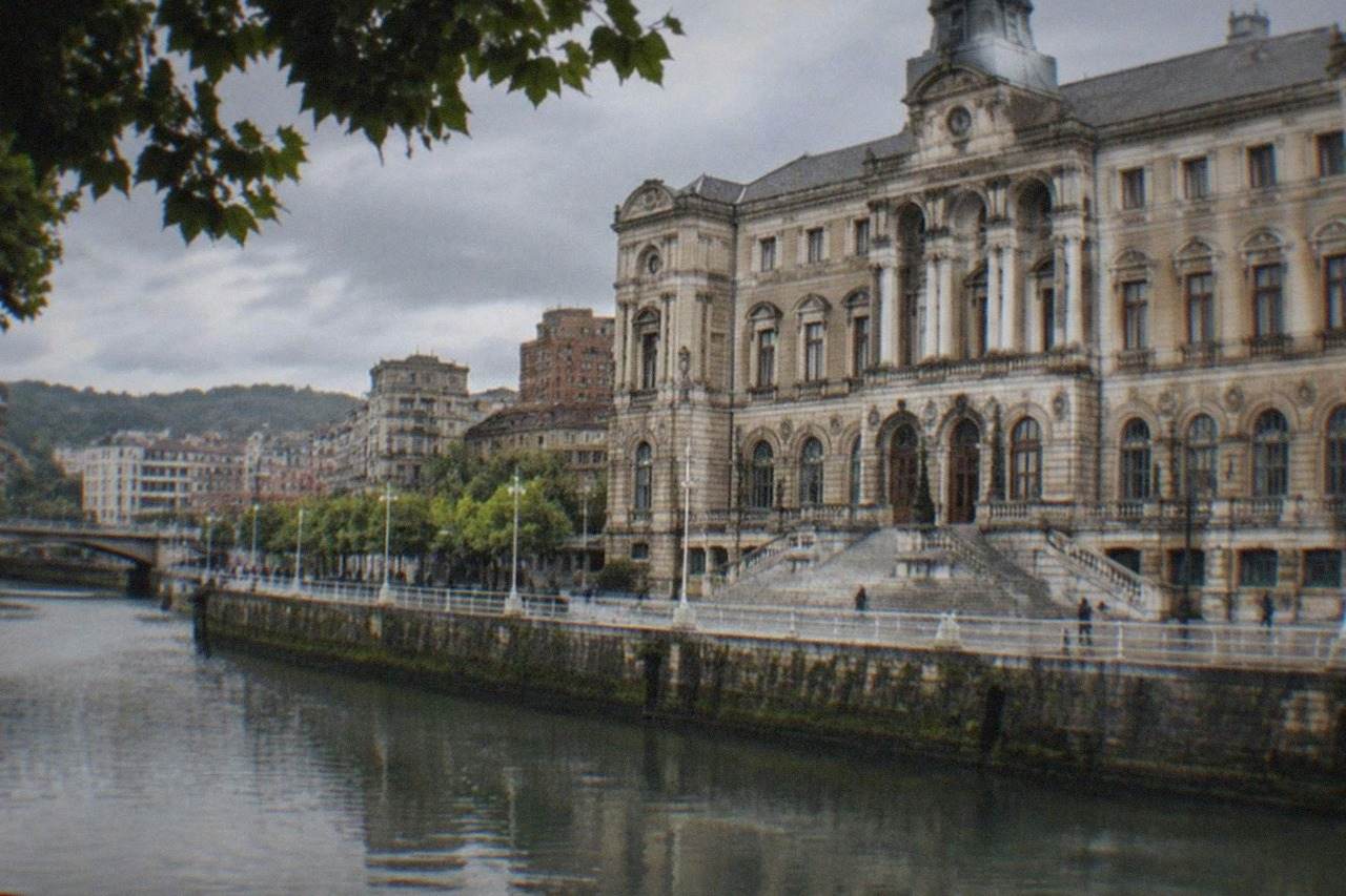 The ornate facade of Bilbao City Hall beside the Arenal promenade with the estuary behind it