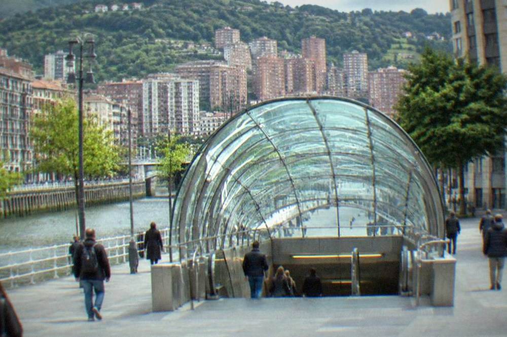 A metro entrance in central Bilbao with the Fosteritos canopy glowing in daylight