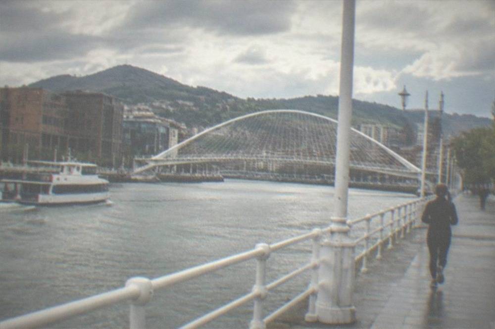 The white curved arch of the Zubizuri footbridge spanning the Nervion estuary