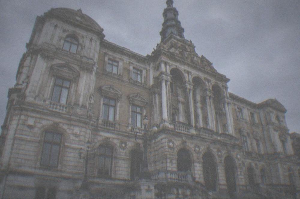 The sculpted balconies and columns of the City Hall facade seen from below