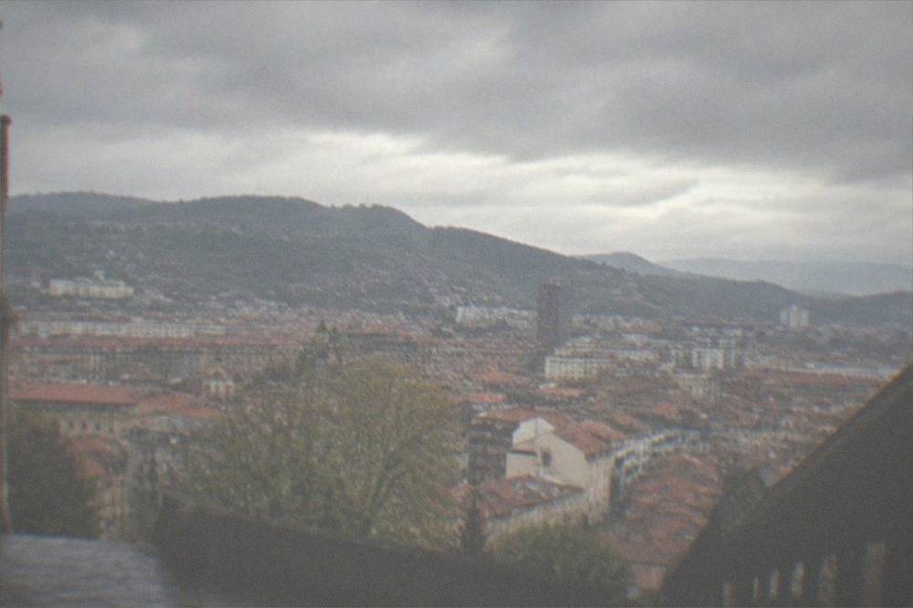 Rooftops of a historic old town seen from a hilltop church esplanade in Bilbao
