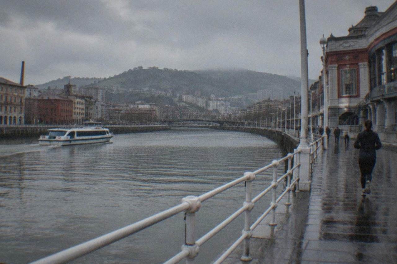The riverside facade of a large market hall beside the Nervion estuary in Bilbao's old town