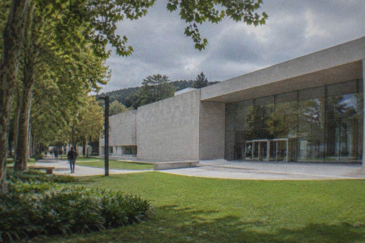 The stone and glass facade of the Museum of Fine Arts Bilbao beside Doña Casilda park