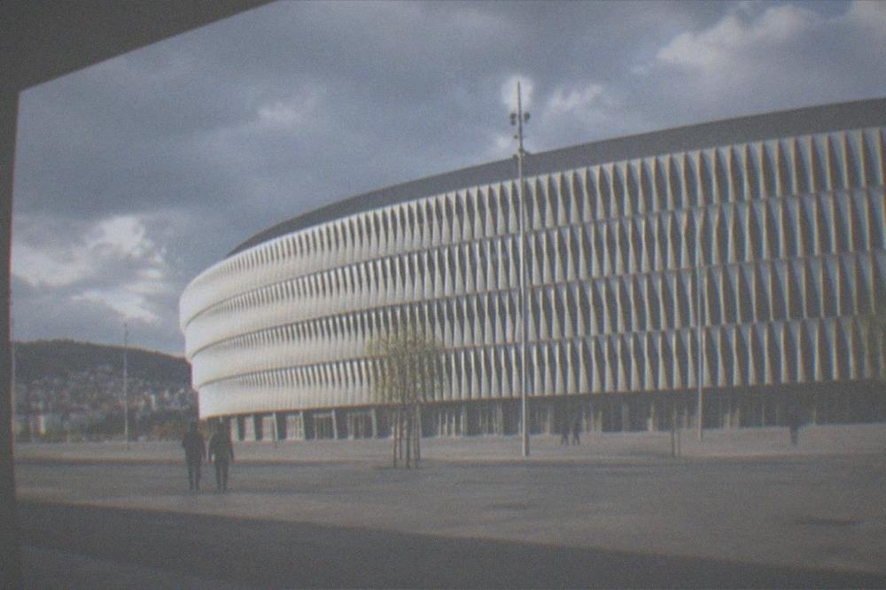 The white lattice facade of San Mames Stadium glowing in late afternoon sunlight in Bilbao