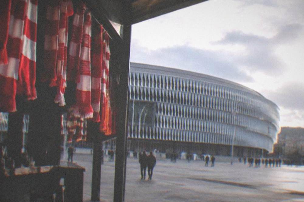 Red and white Athletic Club scarves hanging above a bar entrance near San Mames Stadium in Bilbao