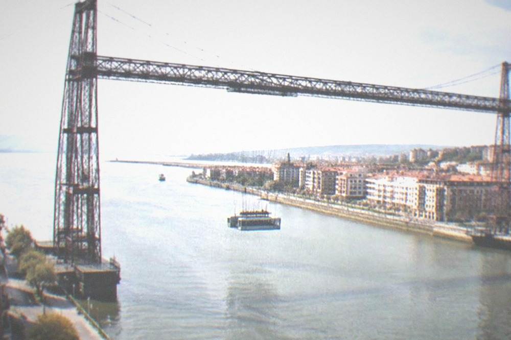 The iron lattice towers of the Vizcaya Bridge against a clear afternoon sky