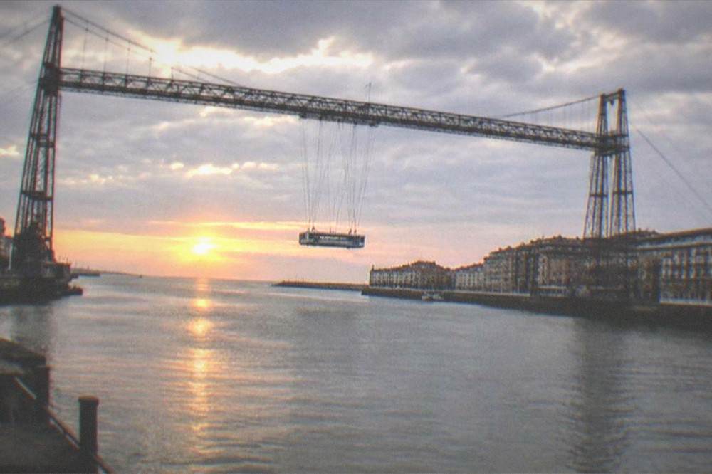 The Vizcaya Bridge at sunset with the estuary and Atlantic horizon beyond
