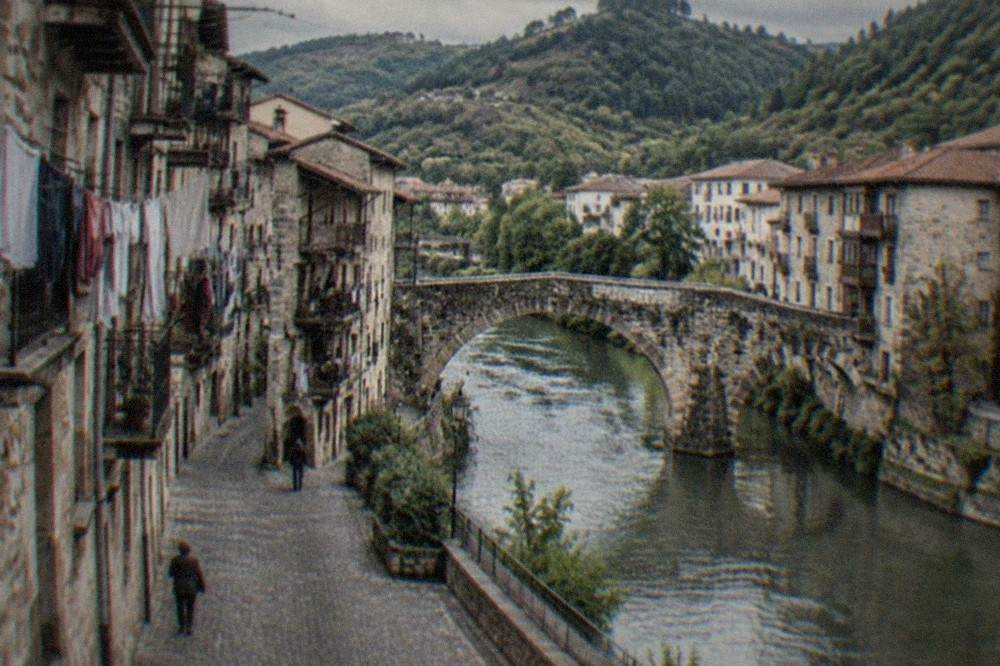Narrow cobbled street in a Basque old town with tall stone buildings and laundry strung between balconies