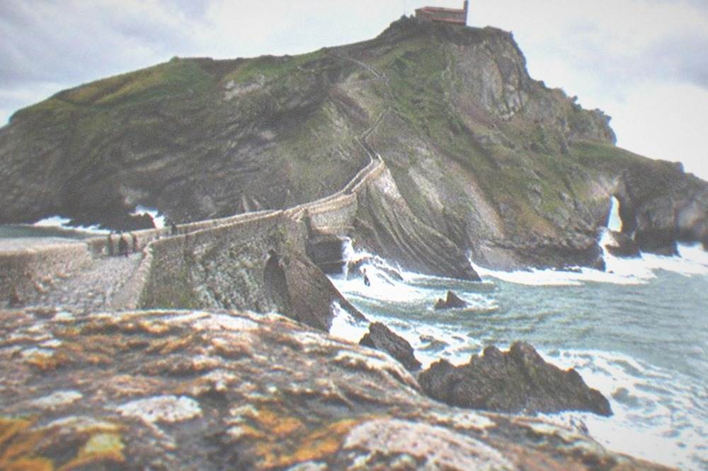 Waves breaking against the cliffs below the causeway at San Juan de Gaztelugatxe on a windy day