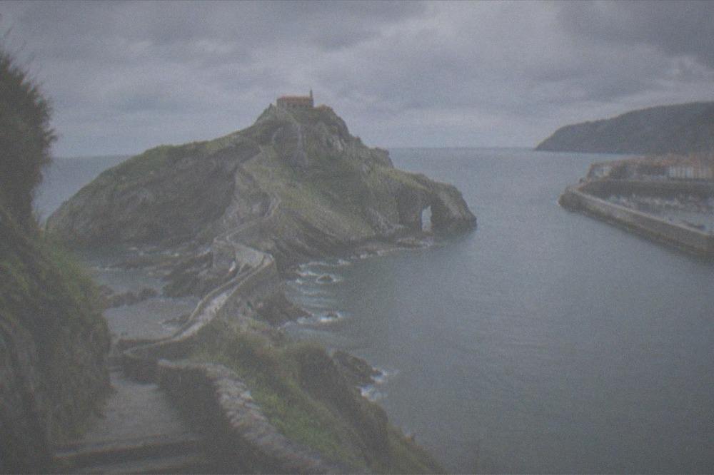 The fishing port and old town of Bermeo with boats moored along the harbour wall