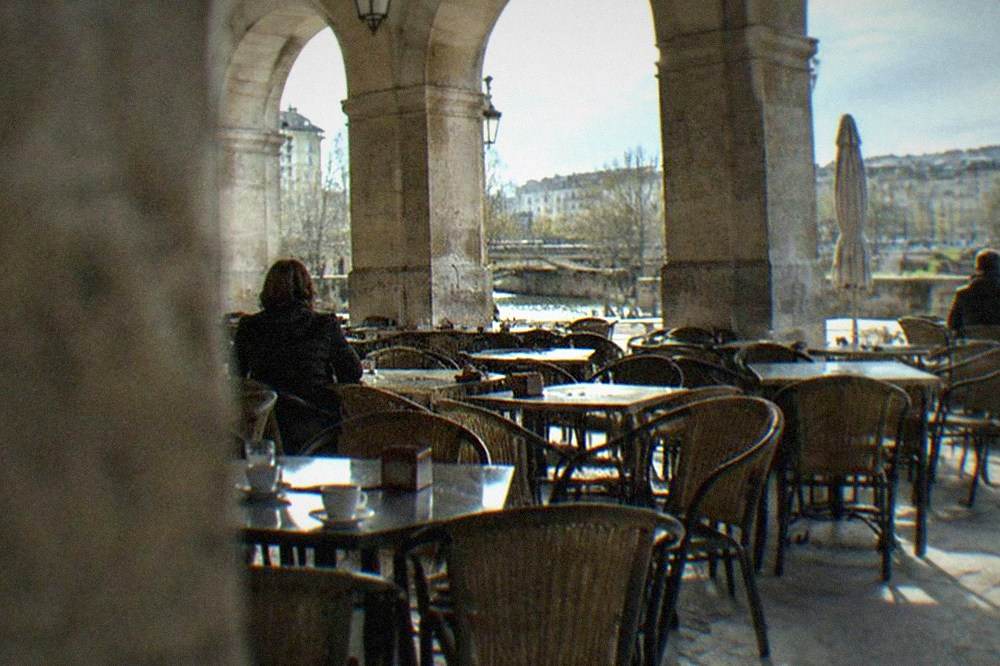 An arcaded square in Pamplona with cafe tables under stone arches