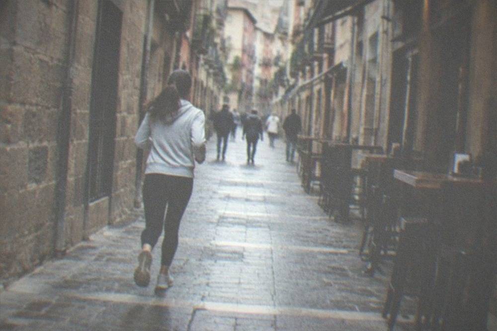 A narrow old street in Pamplona lined with pintxo bars and traditional shopfronts