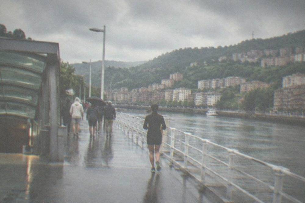 Metro station entrance on the Bilbao coast with beachgoers walking past