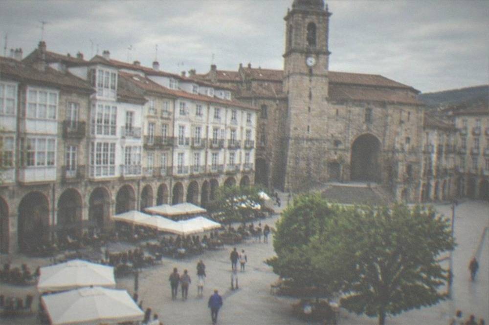 Plaza in Vitoria-Gasteiz old town with arcades, cafes and people sitting outdoors