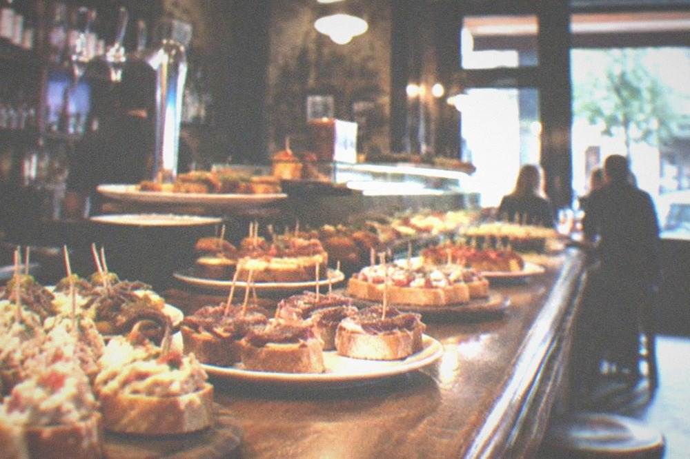 Interior of a traditional Basque bar in Vitoria-Gasteiz with pintxos displayed on the counter