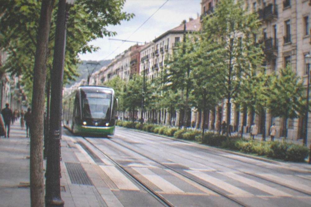 Flat tree-lined street in the Ensanche district of Bilbao with tram tracks and accessible crossings