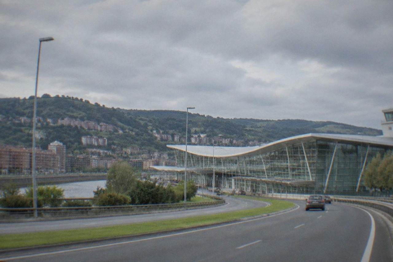The terminal building of Bilbao Airport seen from the approach road on a clear morning
