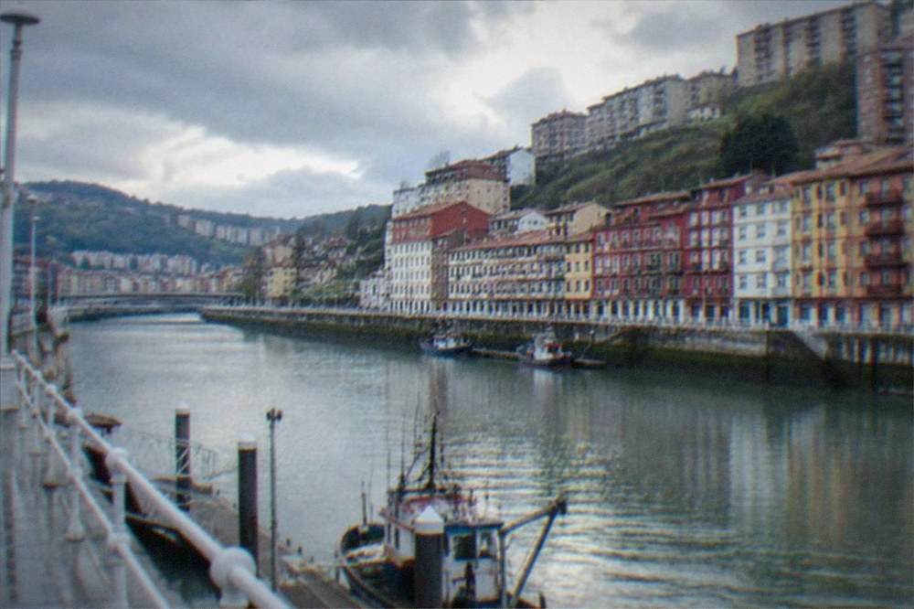 Colourful harbour houses stacked above a small fishing port on the Basque coast