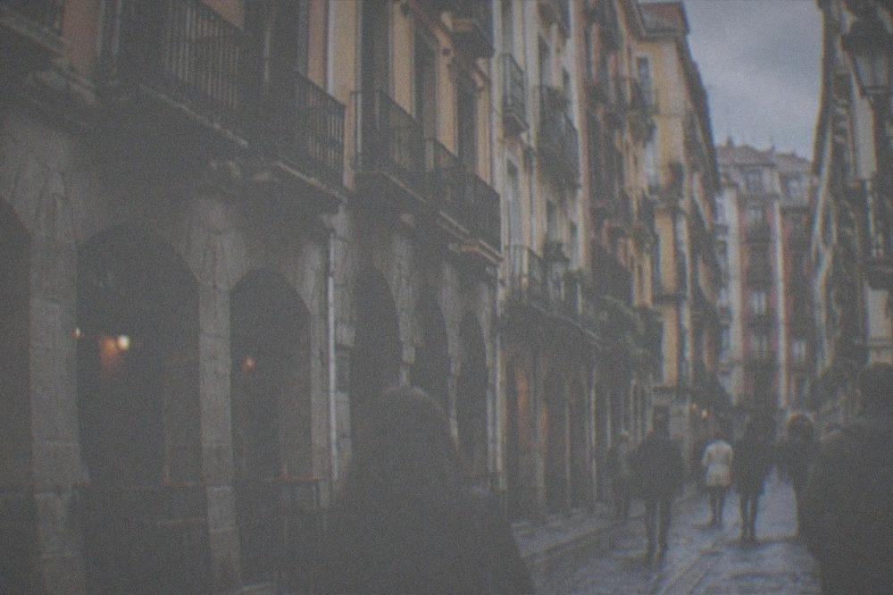 Visitors walking through the narrow Seven Streets of Bilbao's Old Town past traditional shopfronts