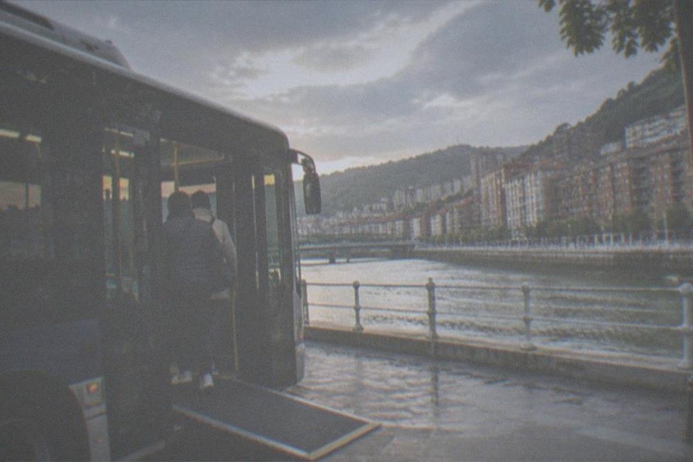 Low-floor city bus with a ramp deployed at a stop in Bilbao