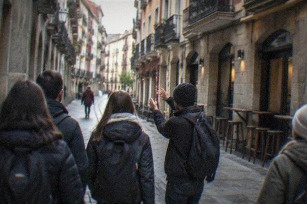 Travellers walking with a guide through the narrow seven streets of Bilbao's old town
