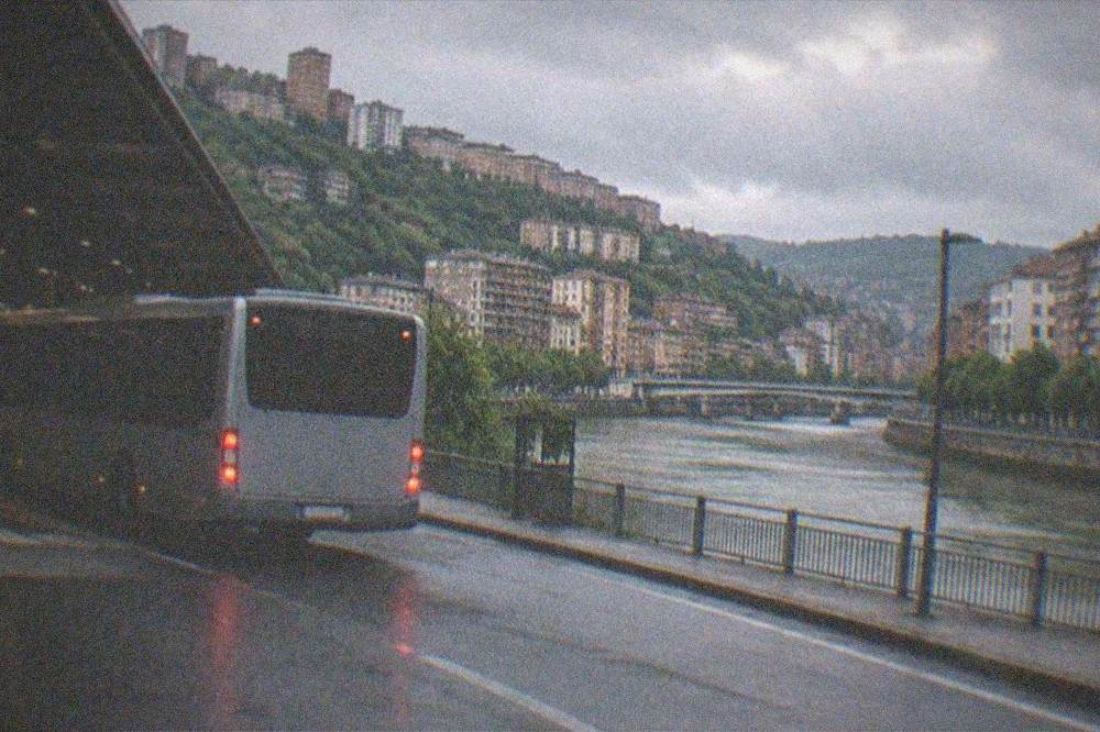 Bus pulling out of a covered interchange bay in Bilbao in soft evening light
