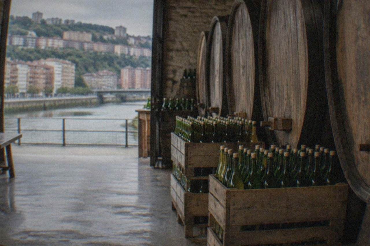 Bottles of Basque cider stacked in the wooden barrels area of a traditional cider house