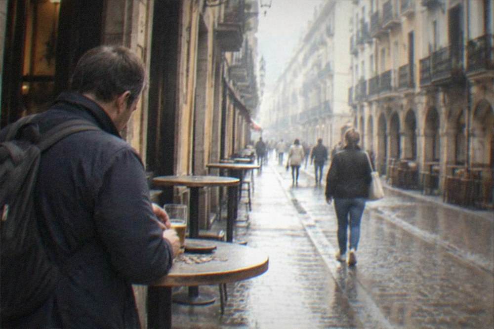 A traveler counting euro coins at a standing bar table in Bilbao's Casco Viejo