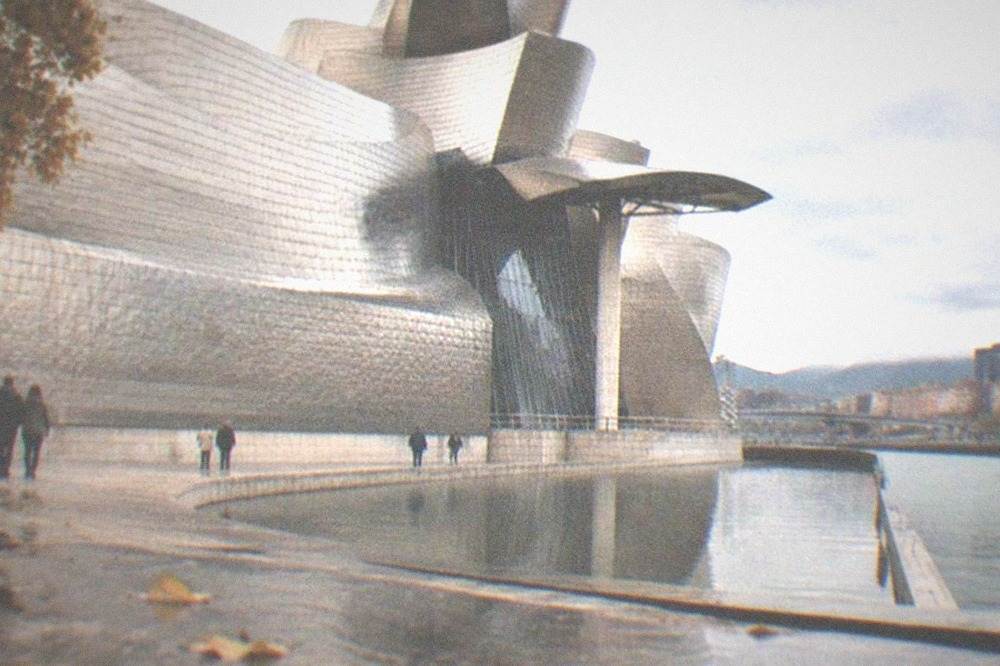 The Guggenheim Museum Bilbao's titanium curves reflecting an overcast autumn sky