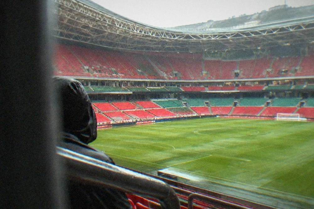 Inside San Mames stadium with empty red and green seats and the pitch in view