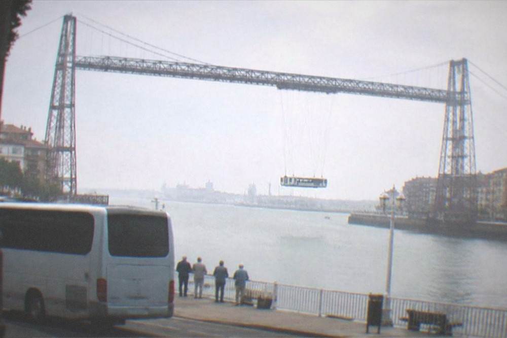 A coastal day trip bus parked near the Vizcaya transporter bridge at Getxo