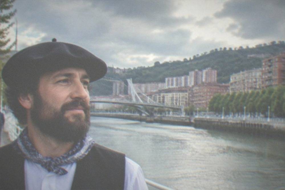 A close view of a carved Basque inscription on the wall of a public building in Bilbao
