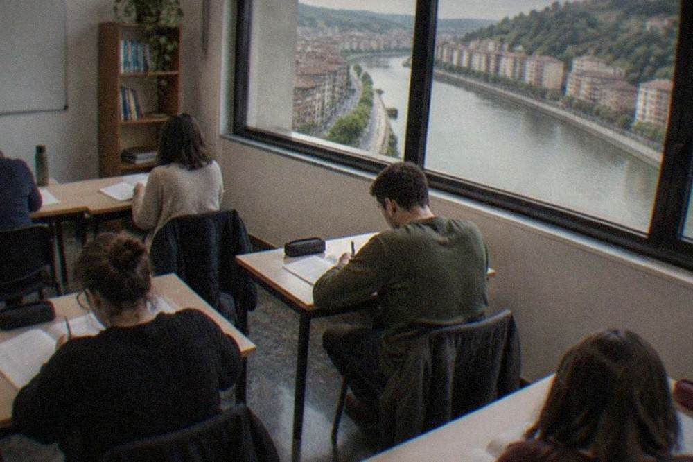 A small classroom with adult students working through Spanish exercises on paper
