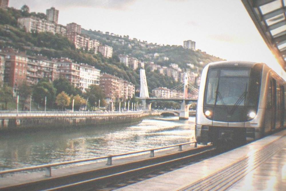A sleek metro train pulling into a bright Bilbao metro station designed by Norman Foster