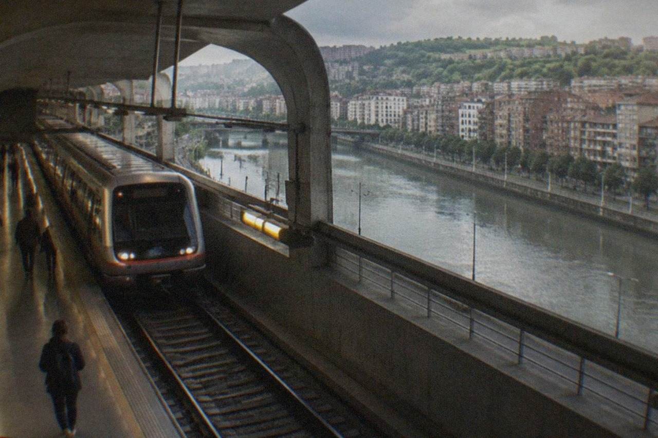 A Bilbao Metro station platform with a train arriving under curved concrete ceilings