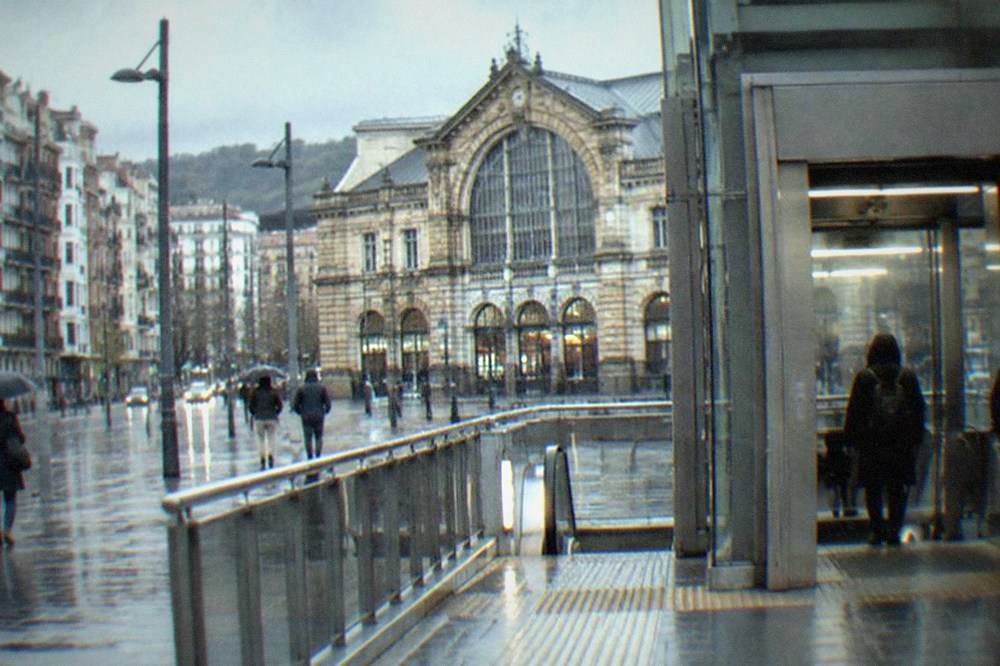A wide metro station elevator opening onto a platform with tactile paving