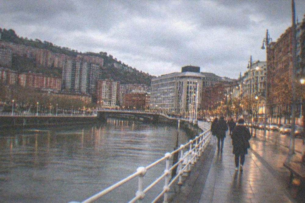 Bilbao's illuminated Gran Via with festive street lights and evening traffic