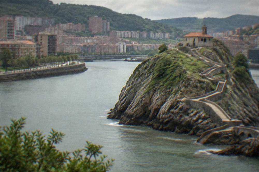 A stone causeway zigzagging up to a hermitage chapel on a rocky islet above the sea