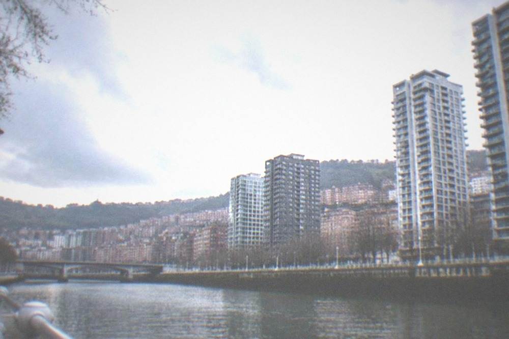 Contemporary residential towers in central Bilbao seen across the river on an overcast afternoon