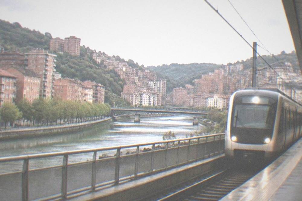 Metro station platform in Bilbao with a train arriving