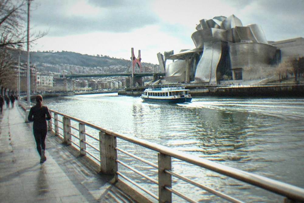 The titanium curves of the Guggenheim Museum Bilbao beside the Nervion river