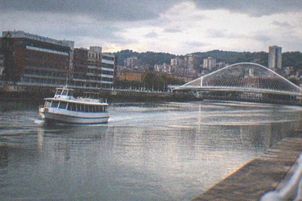 Evening light over the Nervion river with the Zubizuri bridge and city skyline