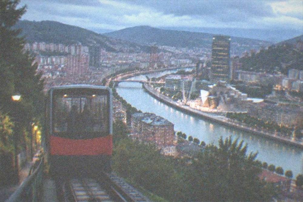 The funicular car climbing the hillside toward the Artxanda viewpoint above Bilbao