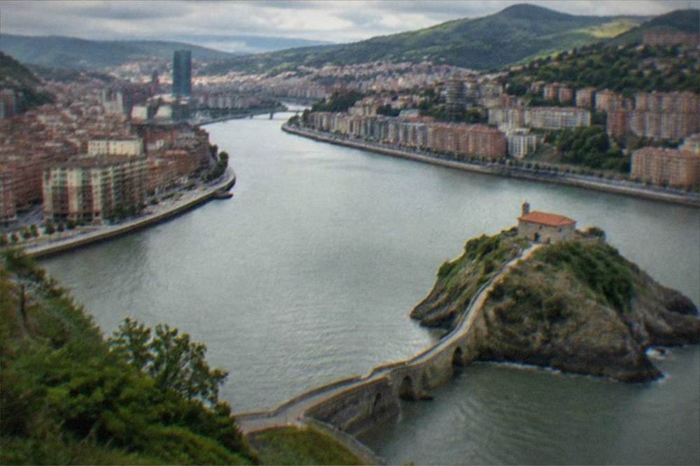 A coastal stone causeway leading to a small hermitage on a rocky islet in the Basque Country