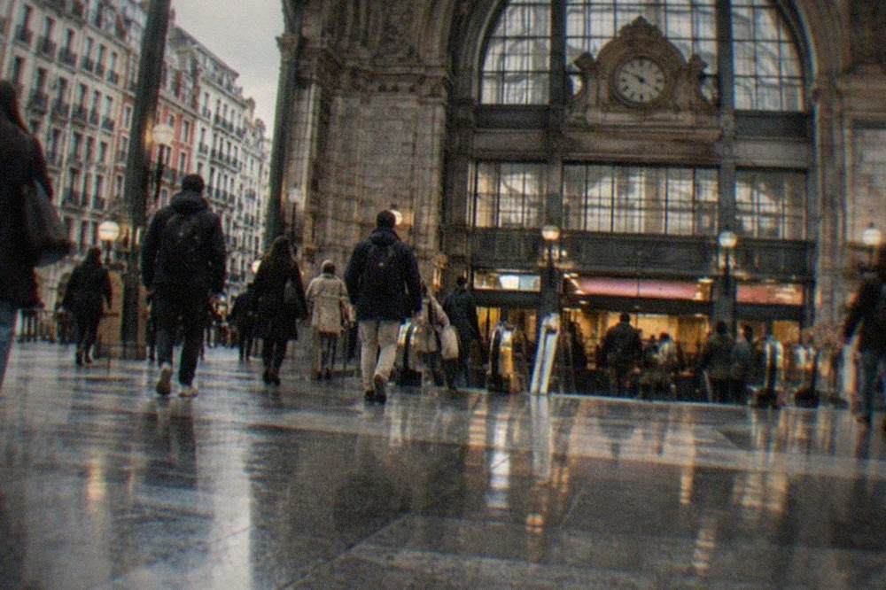 Commuters walking through the concourse of Bilbao Abando station toward the metro entrance