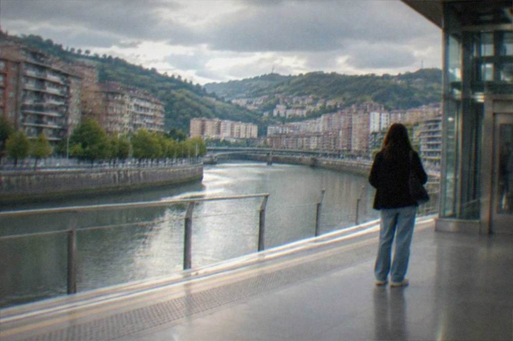 A wide metro platform in Bilbao with tactile paving and an elevator entrance