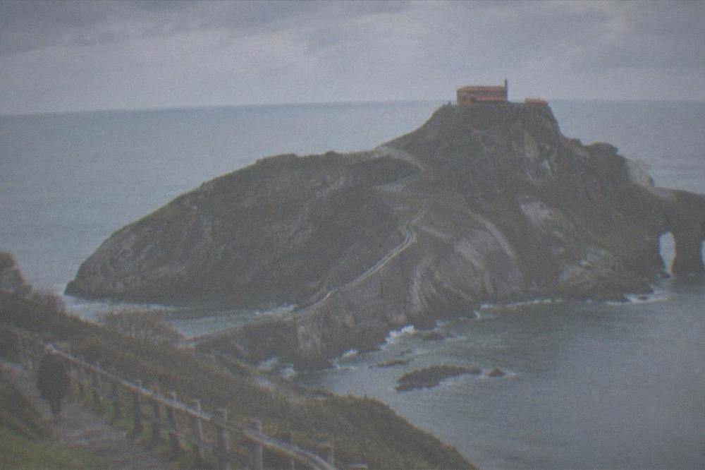 Coastal path overlooking the Gaztelugatxe islet and its stone bridge in the Basque Country