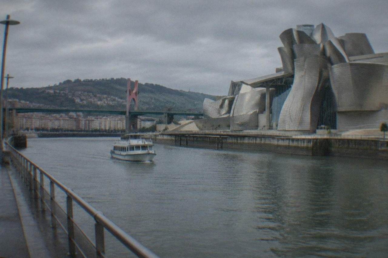The Guggenheim Museum Bilbao beside the Nervion estuary on a bright day